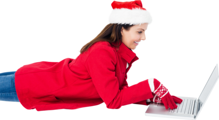 Brunette with santa hat lying on floor using laptop