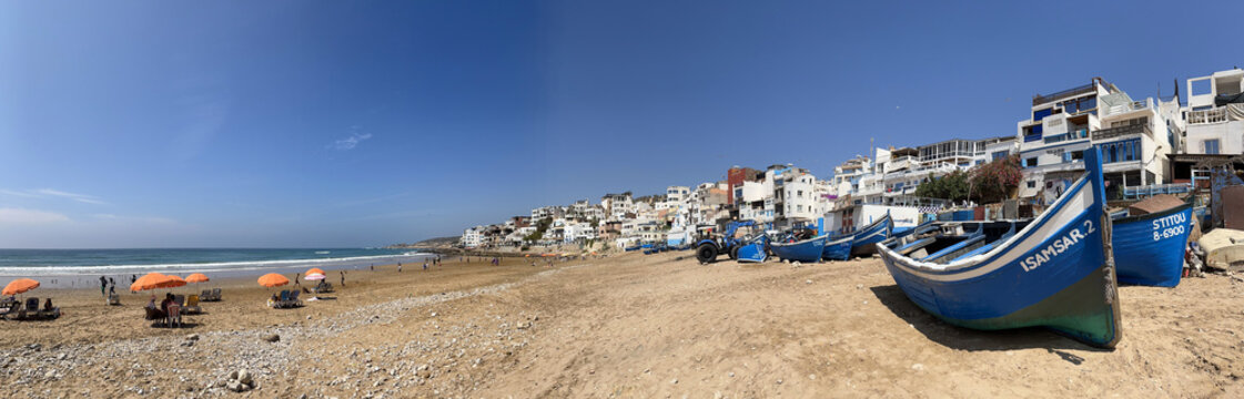 Morocco, Africa: panoramic view of old boats and the skyline on the beach of Taghazout, small fishing village, whose inhabitants are mostly of Berber origin, near Agadir in southwestern Morocco
