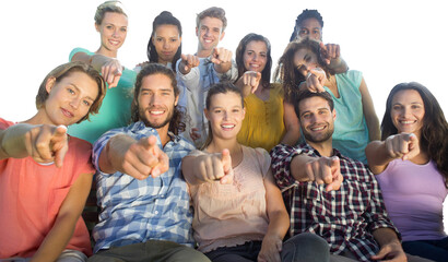 Smiling friends pointing at camera