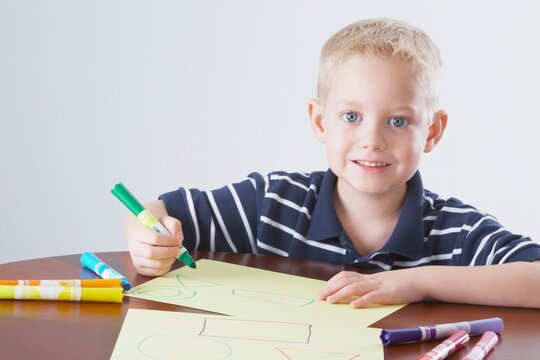 Knoxville, Tennessee, United States Of America; A Boy Coloring At A Table