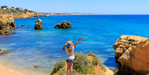 Happy woman traveling in Portugal- Tour tourism in Algarve beautiful beach