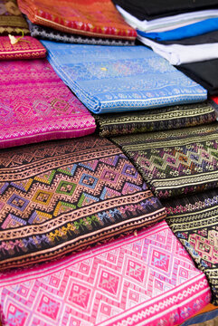 Colourful silk fabrics displayed for sale; Mae Sariang, Thailand