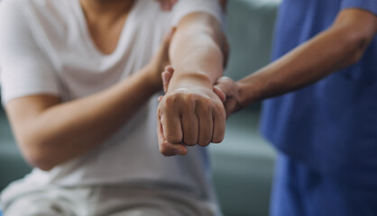 Doctor or Physiotherapist working examining treating injured arm of athlete male patient, stretching and exercise, Doing the Rehabilitation therapy pain in clinic.