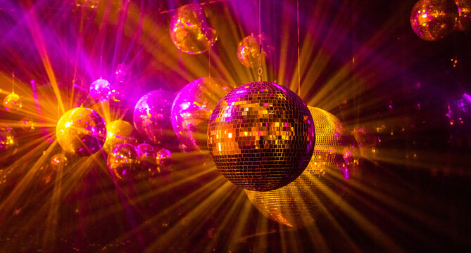 disco background with disco balls in purple and gold lighting