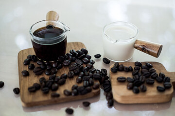 Hot espresso coffee shot and cold milk shots with coffee beans ready to mix coffee. Close up