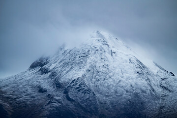 Majestic mountain peak covered in snow and mist in Tombstone Territorial Park along the Dempster Highway; Dawson City, Yukon, Canada