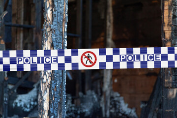 Australian Police tape barricading a burnt house