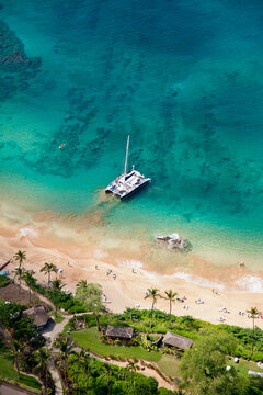 Aerial view of a catamaran moored along the shore at Maluaka Beach which fronts the Makena Beach Resort (formerly Maui Prince) under new development; Makena, Maui, Hawaii, United States of America