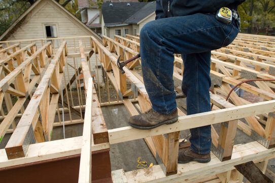 Worker framing a building on a construction site; Lincoln, Nebraska, United States of America