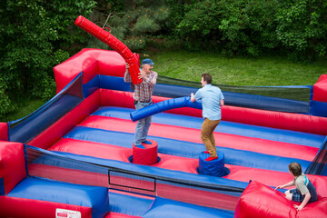 Two men battle in an inflatable jousting ring; Lincoln, Nebraska, United States of America
