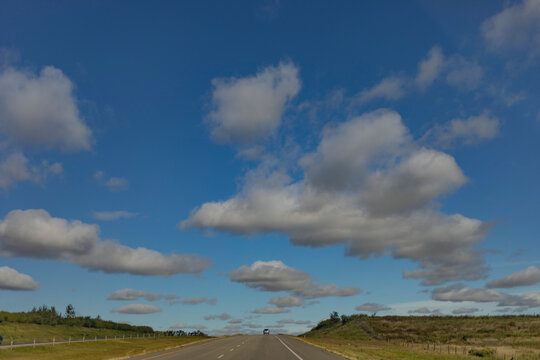 Big sky with clouds over a highway in Alberta, Canada; Alberta, Canada