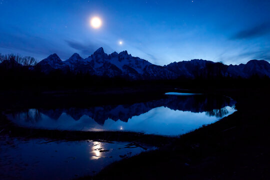 Moon over the Teton Range in Grand Teton National Park, Wyoming, USA; Wyoming, United States of America
