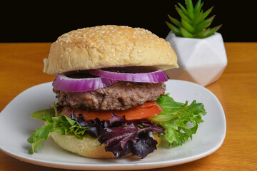 hamburger on leafy greens and top with onionss