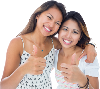 Two smiling asian women giving thumbs up 