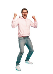 Full length of a cheerful young man standing and celebrating success isolated over transparent background