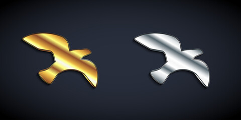 Gold and silver Bird seagull icon isolated on black background. Long shadow style. Vector