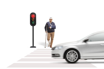 Injured man with a crutch waiting at a pedestrian crossing