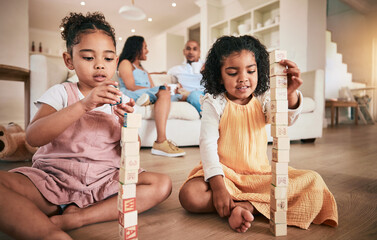 Toys, building blocks and children on a living room floor for bonding, learning and having fun with...