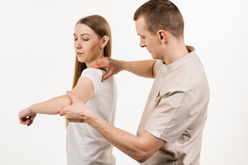 Orthopedic traumatologist examines shoulder joint of patient and checks mobility of movements on...