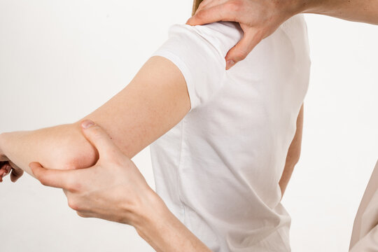 Movement assessment or shoulder joint mobilization. Muscle release.  Orthopedic traumatologist examines shoulder joint of patient and checks  mobility of movements on white background. Stock Photo | Adobe Stock