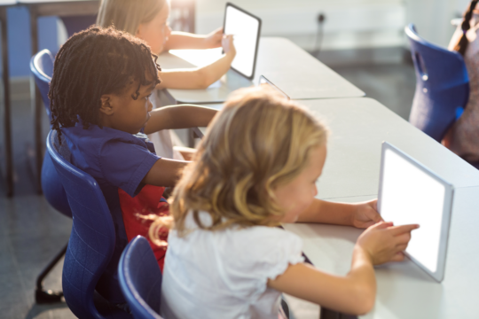 Children using digital tablet