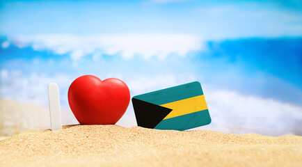 I love Bahamas. Flag of Bahamas on the beach with a red heart. vacation and travel concept.