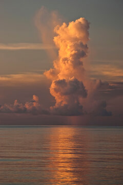 Tall vertical cloud at sunset over the ocean; Seychelles