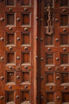 Old-fashioned wooden door with decorative rivets; Stone Town, Zanzibar