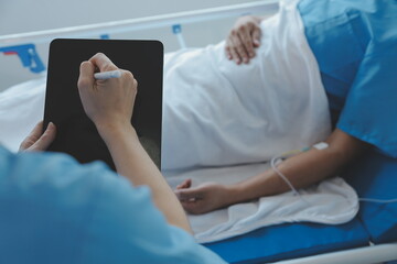 Women Asian doctors hold the patient hand and encourage and provide medical advice While checking...