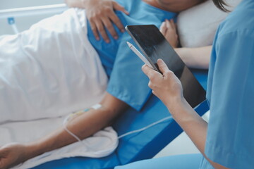 Fototapeta premium Women Asian doctors hold the patient hand and encourage and provide medical advice While checking the patient health in bed. Concept of Care and compassion, antenatal care, Threatened abortion