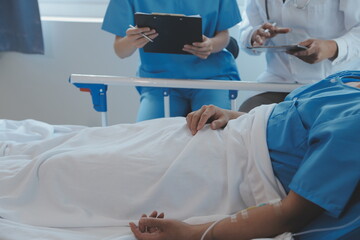 Women Asian doctors hold the patient hand and encourage and provide medical advice While checking...