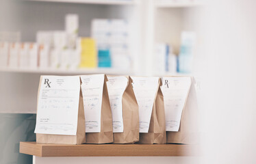 Healthcare, pharmacy and prescription medicine in paper bag, product and pills at counter of drugstore service. Pharmaceutical background, empty retail dispensary and medical supplements in package