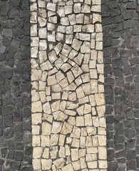 White and black paving stones on the roads of Portugal, top view