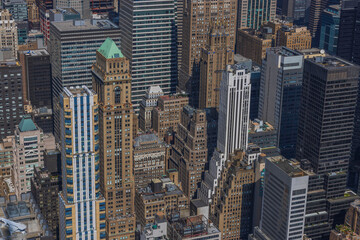 Beautiful top-down view of rooftops of skyscrapers in densely built-up Manhattan. New York, USA.