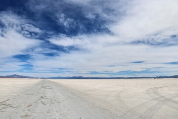 the salt flats of Salinas Grandes in Argentina with cloudy blue sky