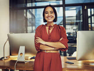 Portrait, smile and late with a business woman in her office, arms crossed while working in the evening at night. Vision, happy and dark with an asian female employee standing at work for dedication