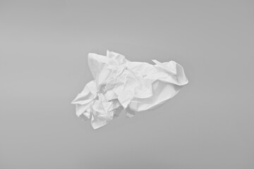 Crumpled sheet of paper on gray background