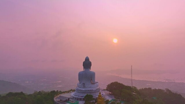 aerial view beautiful sunrise at Phuket big Buddha on the hilltop.. Phuket white big Buddha is the famous landmark in Phuket..Aerial panoramic view landscape sweet sunrise..