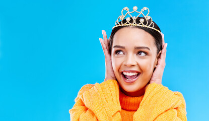 Mockup, crown or happy with woman in studio for celebration, princess and party. Smile, beauty and fashion with female tiara on blue background and excited for achievement, winner and wow prom event © Rene L/peopleimages.com