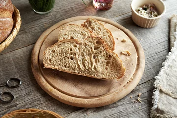 Rollo Brot Slices of sourdough bread on a wooden table  © Madeleine Steinbach
