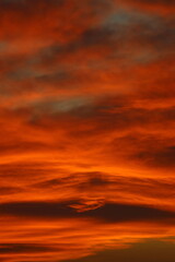 Blurry background of red   sunset sky. Dramatic sky with colorful cloud background. Red burning sunset sky.  Copy space.