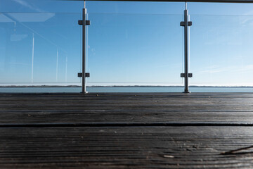 View of the lake from the hotel's terrace with a glass railing