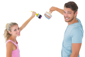 Young couple painting with brushes