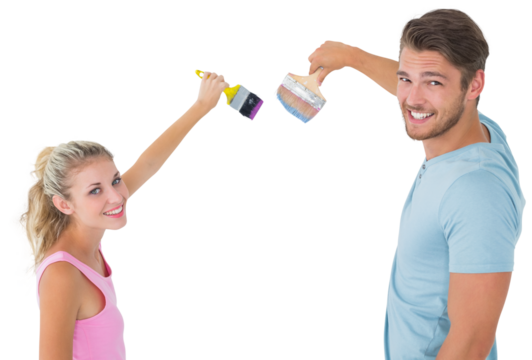 Young couple painting with brushes