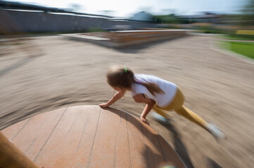 Caucasian girl runs and jumps outdoors.