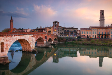 Verona, Italy. Cityscape image of beautiful Italian town Verona with the Stone Bridge over Adige River at sunset.