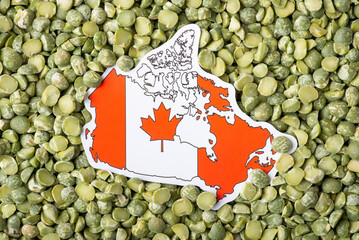 Flag and map of Canada on green pea close up. Origin of pea, growing pea in Canada concept