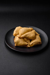 Delicious pancakes triangular shape with meat, salt and spices