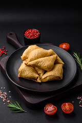 Delicious pancakes triangular shape with meat, salt and spices