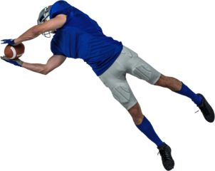 American football player catching ball in mid-air
